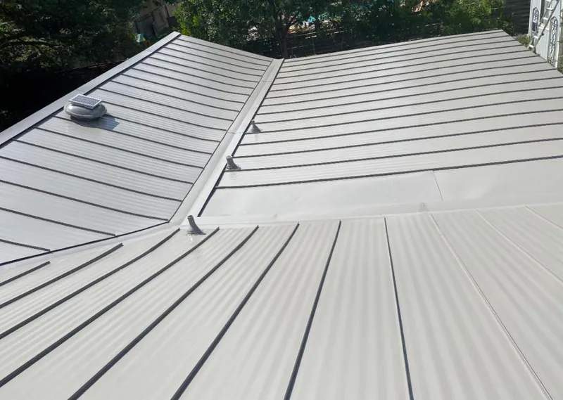 Solar attic fan installed on a metal roof for Roof Ventilation in Rock Island